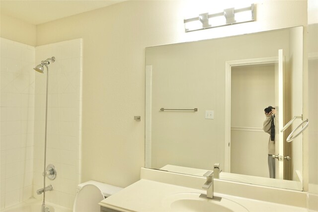 full bathroom with vanity, toilet, and tiled shower / bath combo