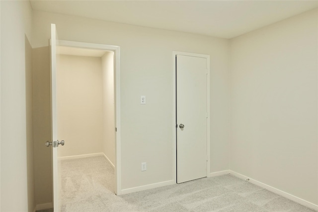 unfurnished bedroom featuring light carpet