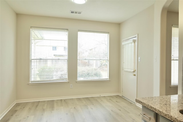 unfurnished dining area with a healthy amount of sunlight and light hardwood / wood-style flooring