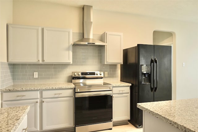 kitchen with electric stove, wall chimney range hood, black fridge with ice dispenser, and white cabinets