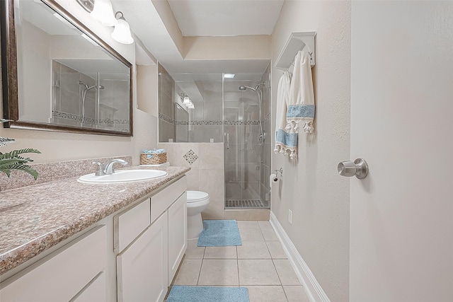 bathroom featuring an enclosed shower, vanity, tile patterned floors, and toilet