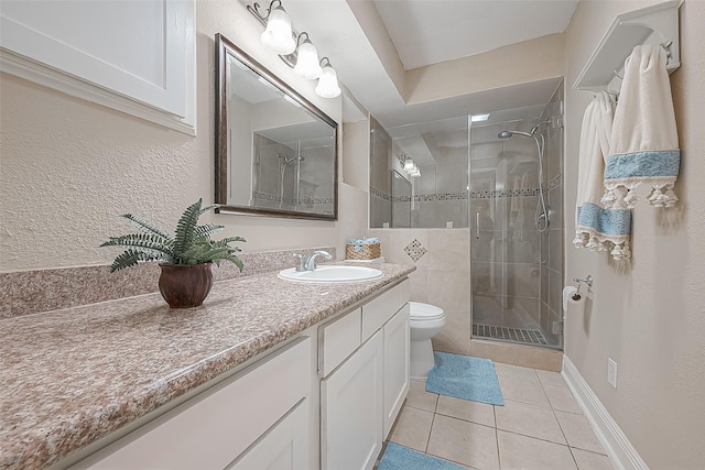 bathroom with tile patterned flooring, vanity, toilet, and an enclosed shower