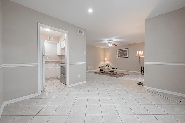 interior space with ceiling fan and light tile patterned floors