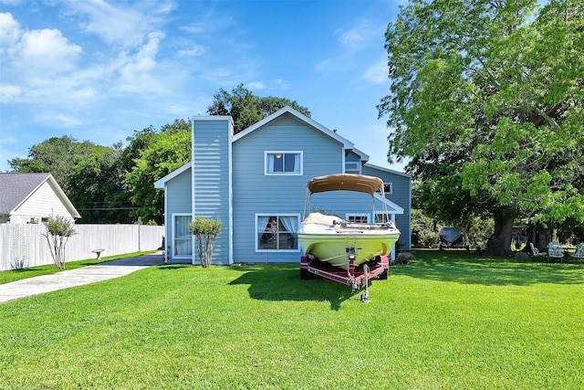 back of property featuring a lawn