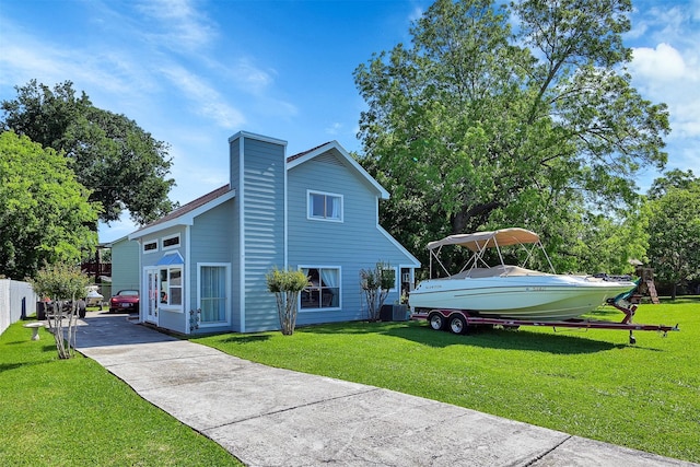 view of side of property with a lawn