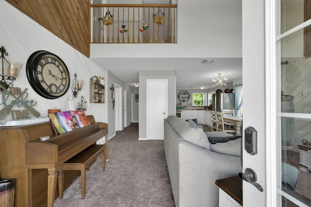 living room featuring a notable chandelier and carpet