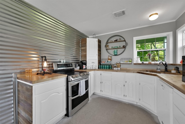 kitchen featuring sink, white cabinetry, double oven range, white dishwasher, and kitchen peninsula