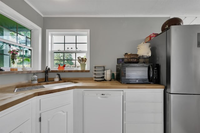 kitchen with white cabinetry, white dishwasher, sink, and butcher block countertops