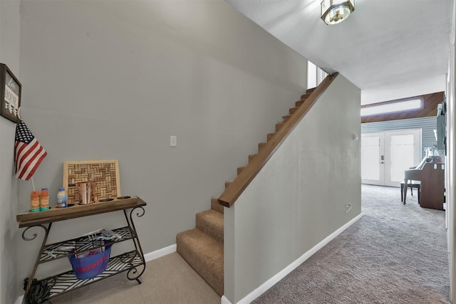 staircase featuring carpet floors and french doors