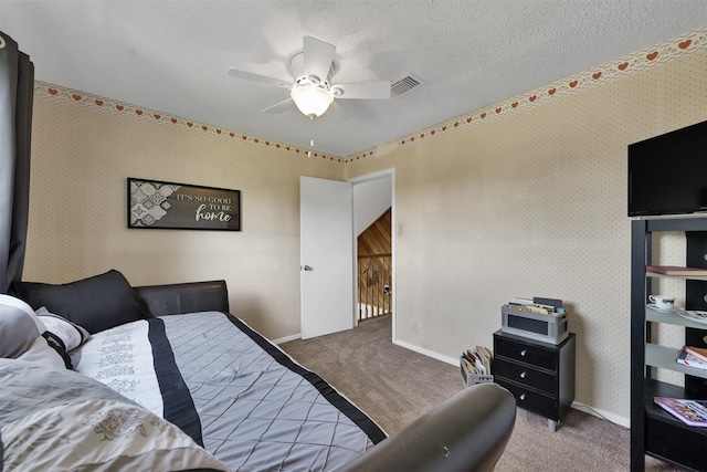 bedroom featuring ceiling fan, a textured ceiling, and carpet flooring