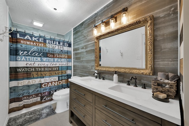 bathroom featuring tile patterned flooring, vanity, a textured ceiling, a shower with curtain, and toilet