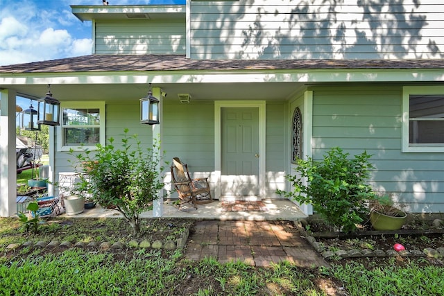 view of exterior entry with a porch