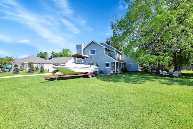 rear view of house featuring a lawn