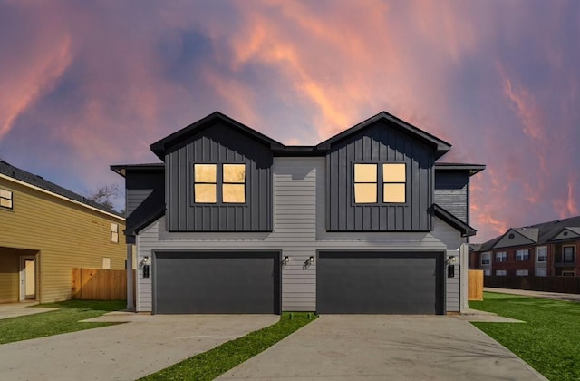 view of front facade with a yard and a garage