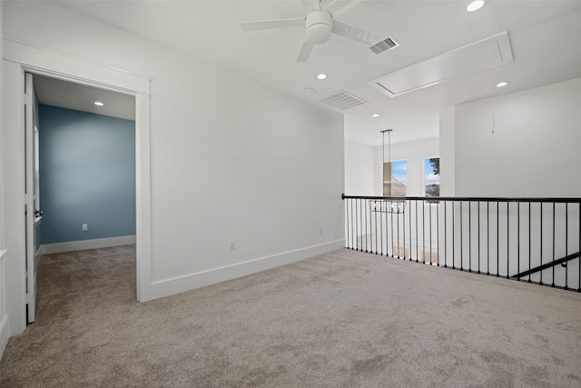 carpeted spare room with ceiling fan