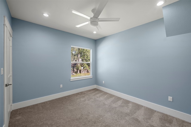 empty room featuring ceiling fan and carpet