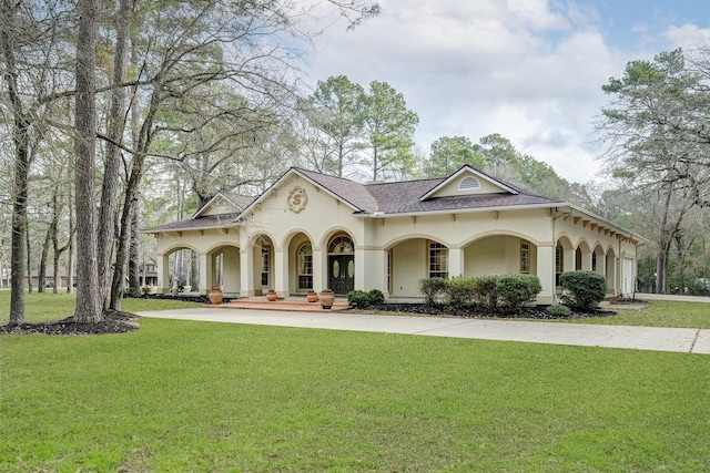 mediterranean / spanish home featuring a front yard and a porch