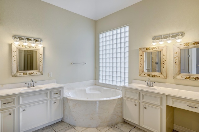 bathroom with vanity, a bath, and tile patterned floors