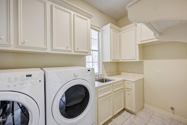 washroom featuring cabinets, separate washer and dryer, and sink