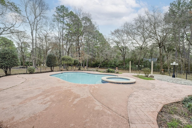 view of swimming pool with an in ground hot tub and a patio