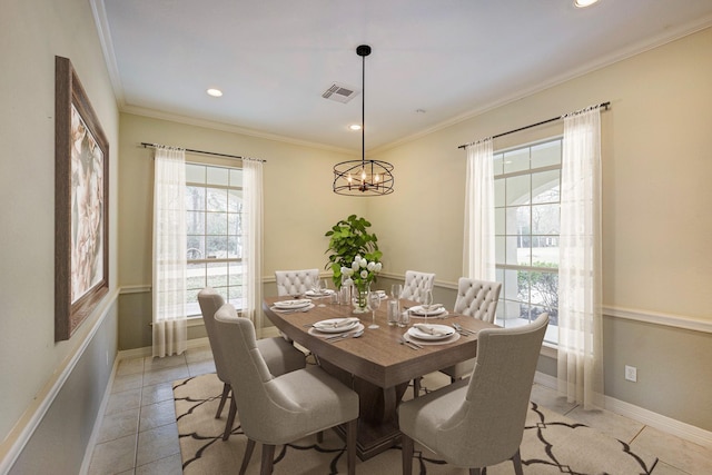 dining area featuring an inviting chandelier, light tile patterned floors, and ornamental molding