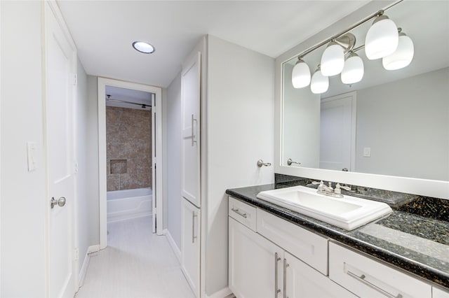 bathroom with vanity and a tub