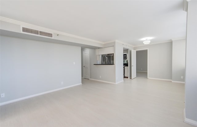 unfurnished living room featuring crown molding and light wood-type flooring