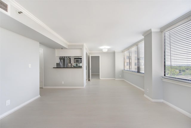 unfurnished living room with crown molding and light hardwood / wood-style flooring