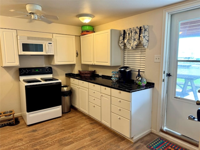 kitchen with electric stove, a wealth of natural light, light hardwood / wood-style floors, and white cabinets