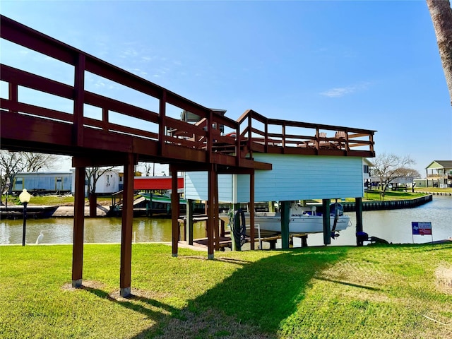 view of dock featuring a water view and a yard