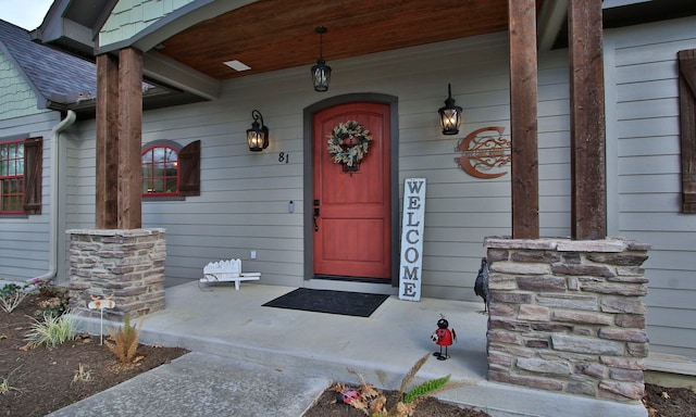 view of exterior entry with a porch