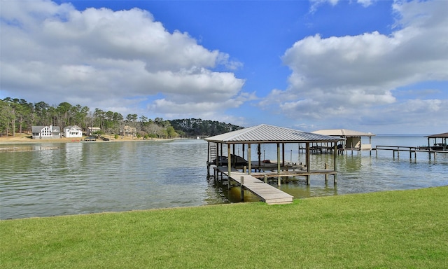 view of dock featuring a water view and a yard