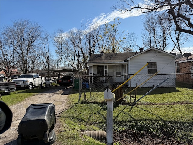 view of yard featuring a carport, fence private yard, and dirt driveway