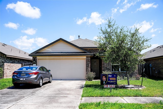 single story home featuring a front yard, brick siding, driveway, and an attached garage