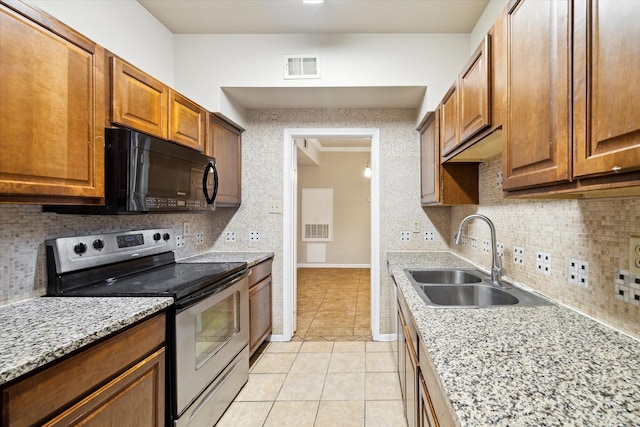 kitchen featuring light tile patterned flooring, tasteful backsplash, sink, electric range, and light stone countertops