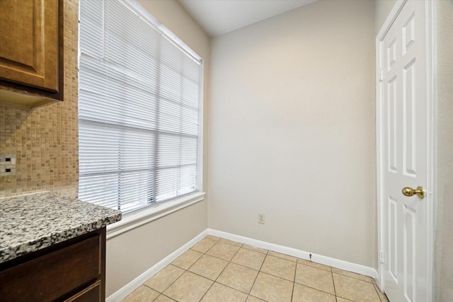 unfurnished dining area featuring light tile patterned floors