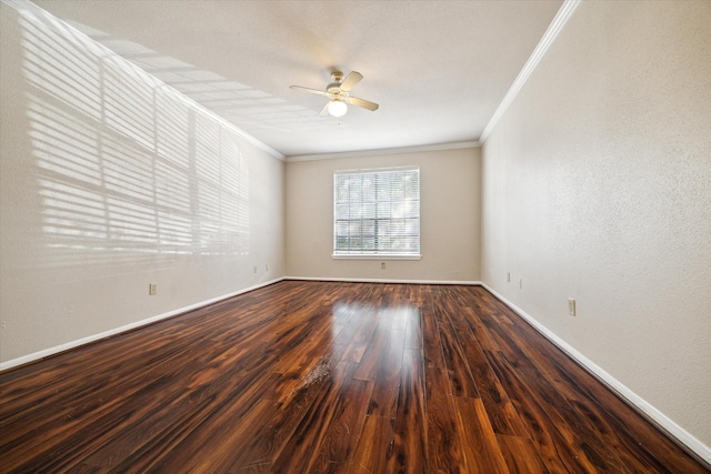 unfurnished room featuring dark hardwood / wood-style flooring, ornamental molding, and ceiling fan