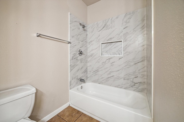 bathroom with tile patterned floors, toilet, and tiled shower / bath combo