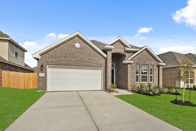 view of front facade with a garage and a front lawn