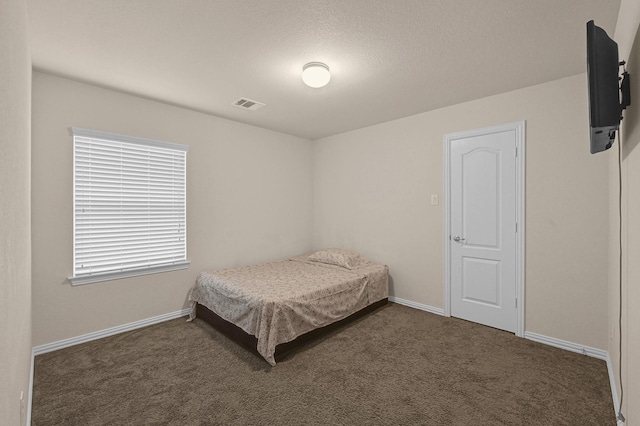 bedroom featuring dark carpet