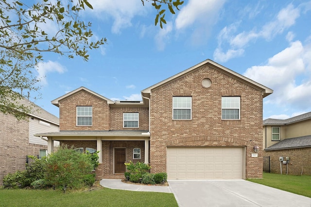 view of front of home with a garage and a front lawn