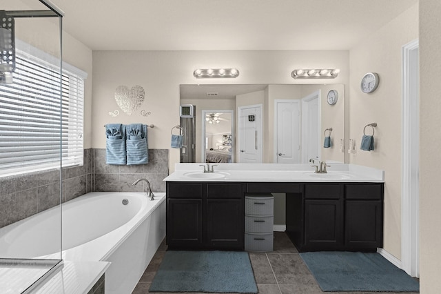 bathroom featuring vanity, a bath, tile patterned floors, and ceiling fan