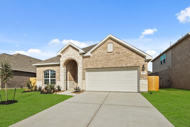 view of front of house featuring a garage and a front lawn