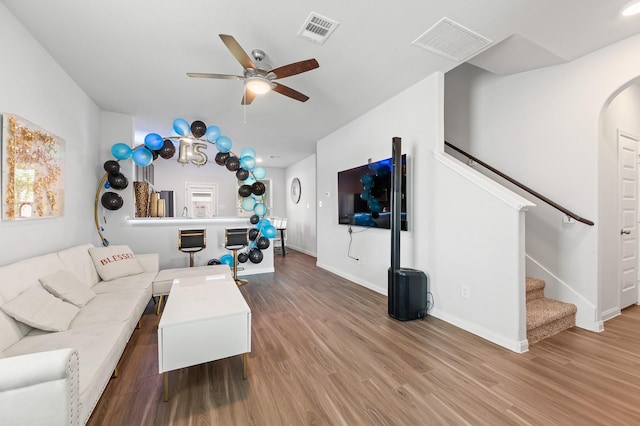 living room with wood-type flooring and ceiling fan