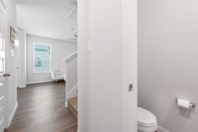 bathroom featuring hardwood / wood-style floors and toilet