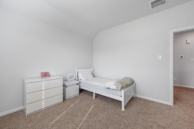 bedroom featuring vaulted ceiling and carpet