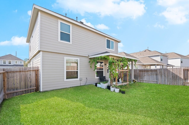 back of house with a yard