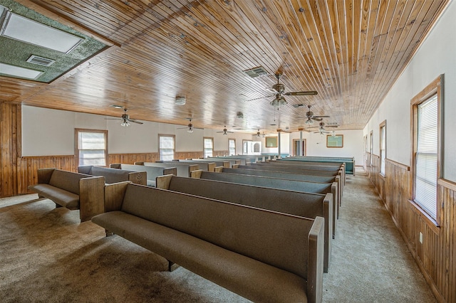 game room featuring light carpet, wood ceiling, and wood walls