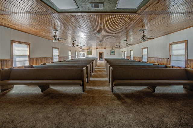 miscellaneous room with wood ceiling, carpet floors, and wood walls