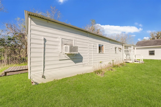 view of side of property with a yard and cooling unit